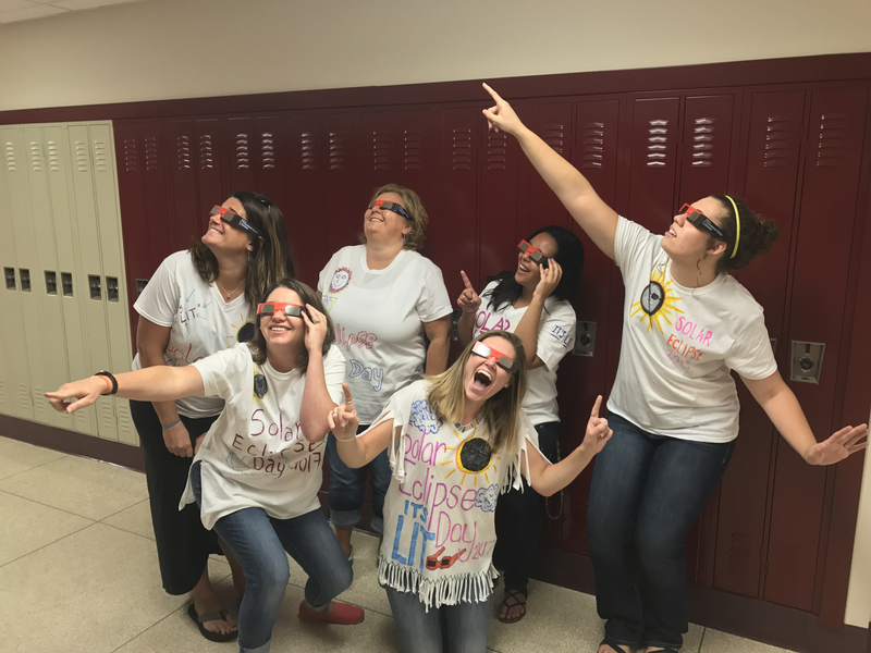 PCMS teachers strike a pose in the eclipse shirts they designed.